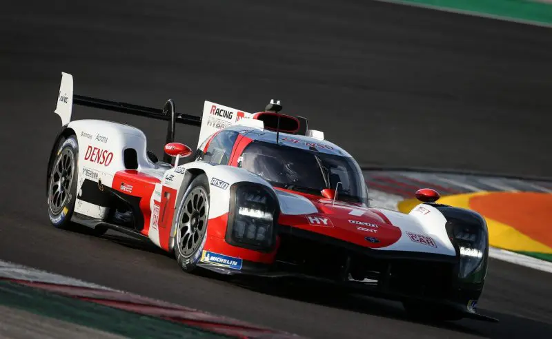 Toyota-WEC-Hypercar-2021-copyright-Toyota-800x492 A red and white Toyota race car speeds around a corner on a racetrack during daylight.