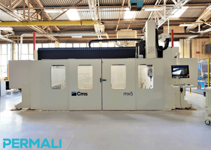 Large industrial CNC machine, CMS mx5 model, inside a bright factory; Permali logo in the bottom left.