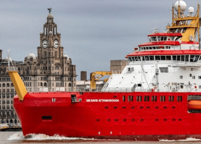 A red and white research ship named Sir David Attenborough sails past the Liver Building in Liverpool.