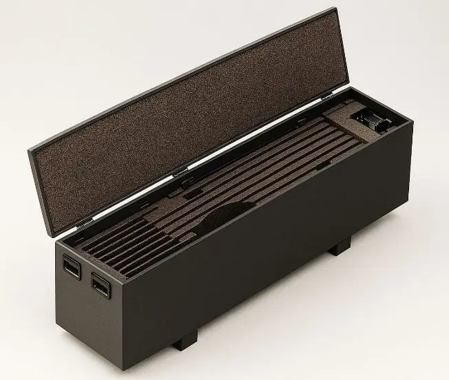 A black rectangular box with an open foam-lined lid and tactical composite flooring compartments.