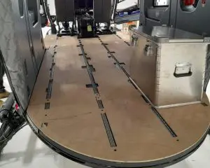 Airbus H145M cargo bay with Tactical Hard-Flooring and a large metal storage box inside.