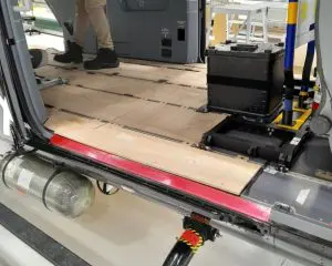 Person standing inside Airbus H145M with tactical hard-flooring and visible technical equipment.