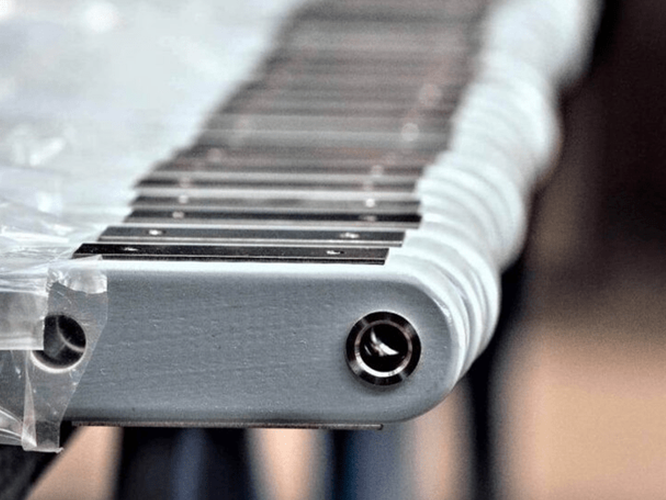 Bespoke-solutions-V2-1200×800-2-800×622 Close-up of a xylophone or glockenspiel with metal bars and a plastic covering on the left side.