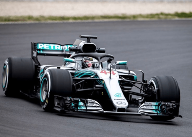 Mercedes-resized-for-website-800×533 A Mercedes Formula 1 car races on a track, featuring the number 44 and Petronas branding.