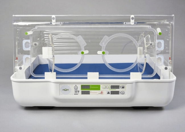 A modern neonatal incubator with a clear enclosure and control panel, used for infant care.