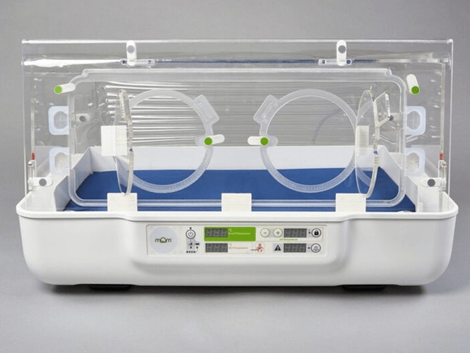 Mom-Incubator-109-1200×801 A modern neonatal incubator with a clear enclosure and control panel, used for infant care.