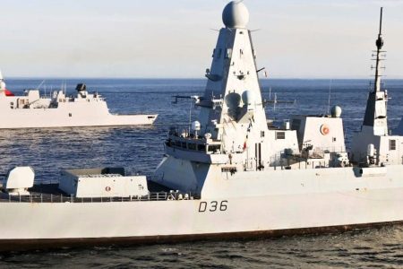 Naval Defence T31 Three naval warships sailing on calm, open sea under a clear sky.