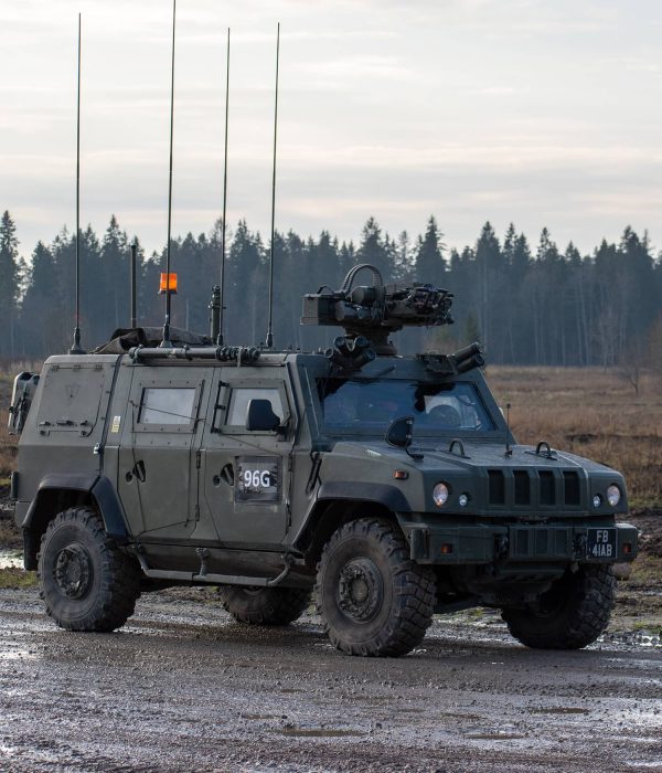 Viking - 45167092 Armored military vehicle with antennas parked on a muddy road near a forest.
